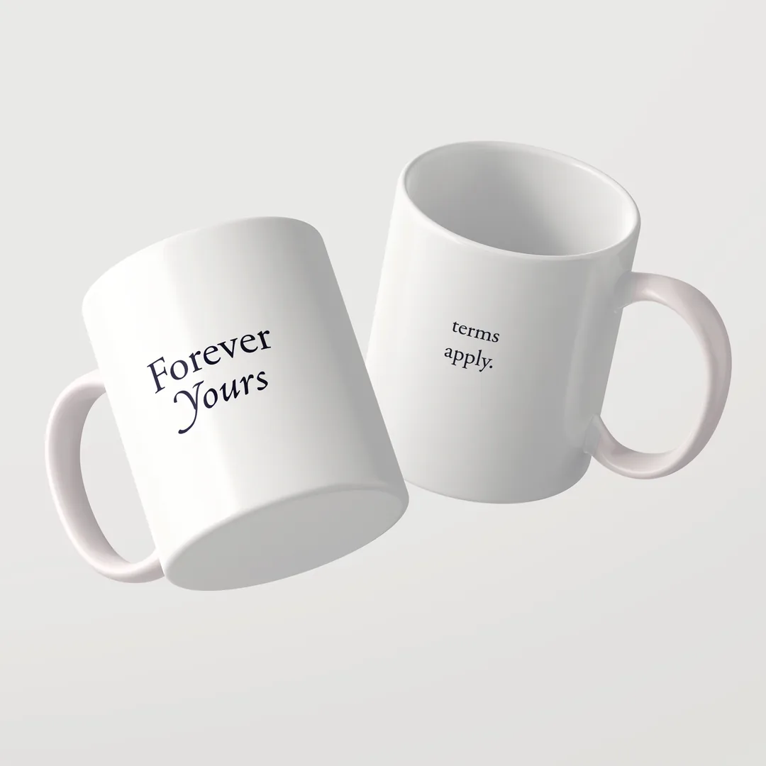 Zwei weiße Forever Yours Tassen von Studio SaySay, auf der einen steht Forever Yours, auf der anderen terms apply.