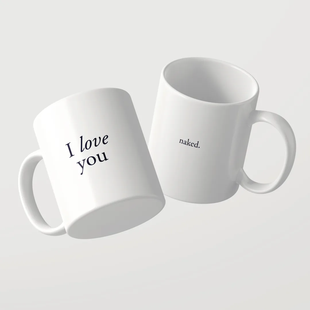 Zwei weiße I Love You Tassen von Studio SaySay, auf der einen steht I love you, auf der anderen naked.